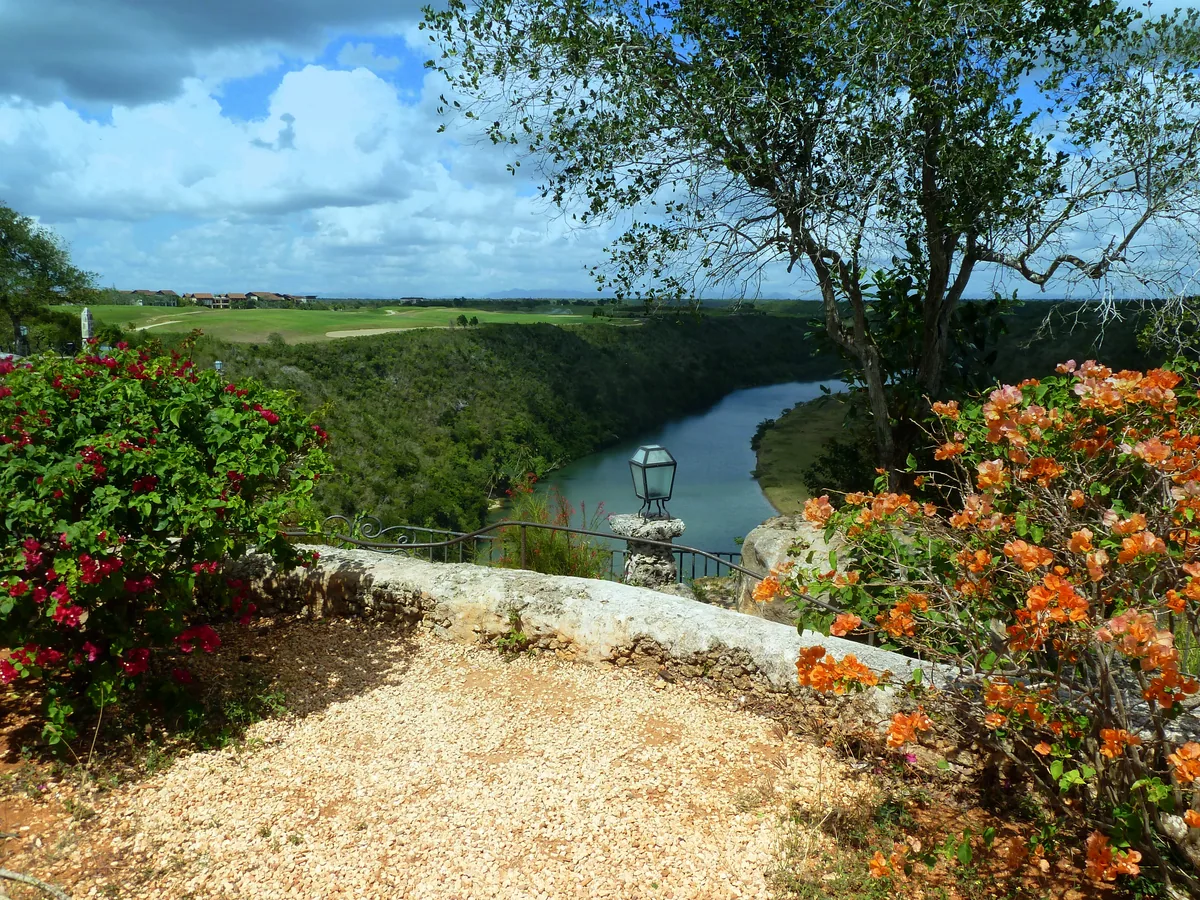 The river valley below Altos de Chavón, flowers on the stone wall