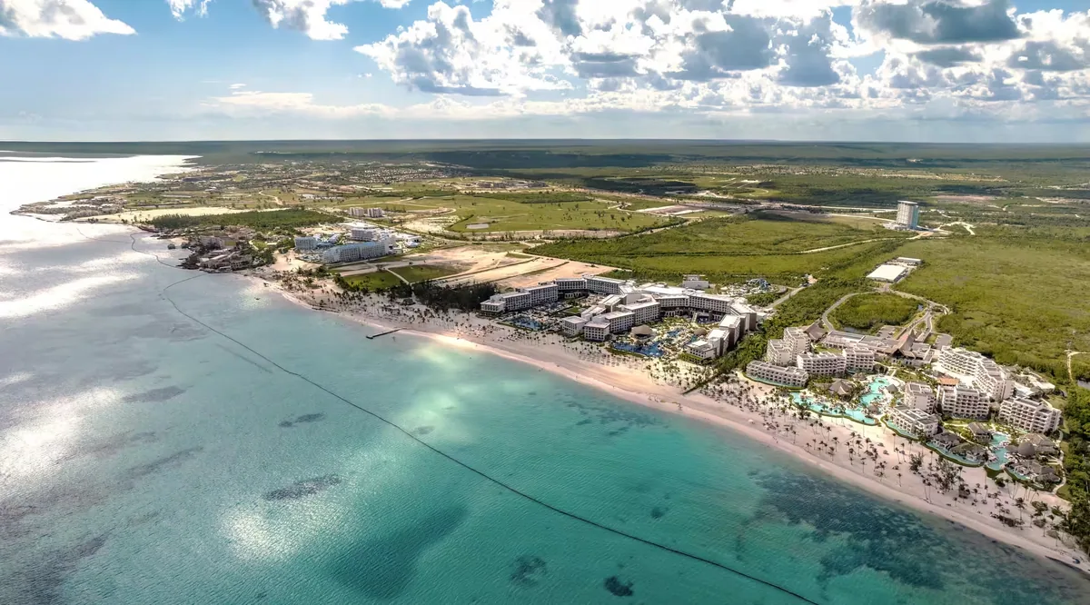 Juanillo from the air: a long white beach and turquoise shallows
