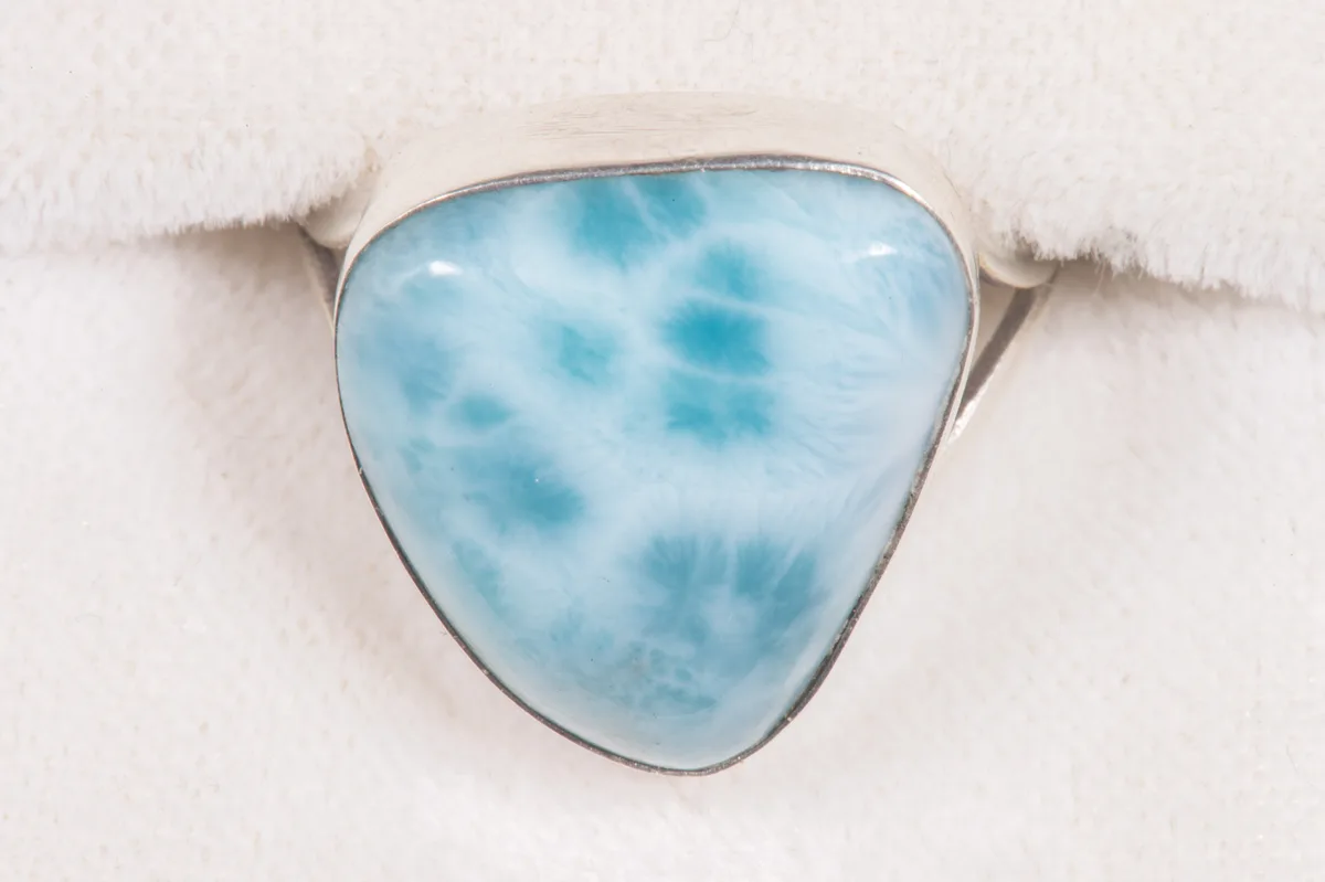 A ring set with larimar, the blue stone marbled with white